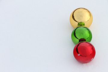 Glass color spheres lying in snow outdoors