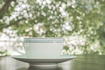 A cup of coffee latte on the wooden table - Vintage Filter Effect