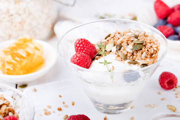 Healthy breakfast. Granola with pumpkin seeds, honey, yogurt, fresh berries .