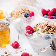Healthy breakfast. Granola with pumpkin seeds, honey, yogurt, fresh berries .