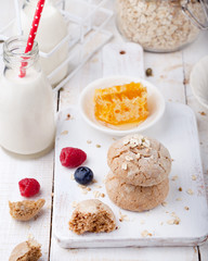 Gingerbread cookies with fresh berries and bottle of milk .