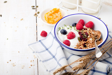 Healthy breakfast. Granola with pumpkin seeds, honey, yogurt ,fresh berries.