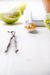 Green tomatoes jam with vanilla pods in a glass jar 