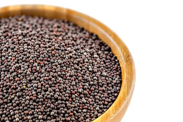 Isolated closeup of black mustard seeds in bowl