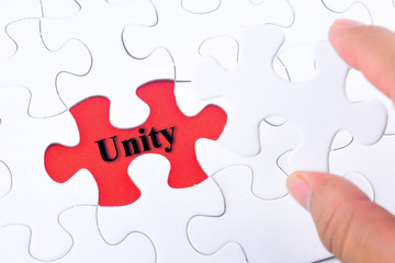 Fototapeta premium Missing jigsaw puzzle piece with word Unity