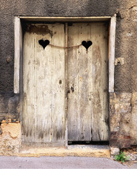 Old double door with two hearts chained