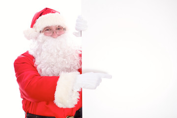 Kind Santa Claus pointing in white blank sign, isolated on white background