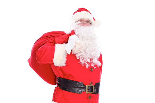 Kind Santa Claus carrying big bag, isolated on white background
