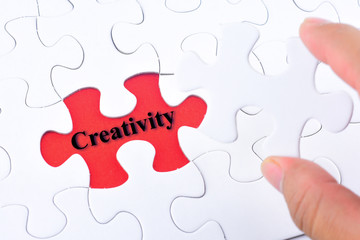 Fototapeta premium Missing jigsaw puzzle piece with word Creativity