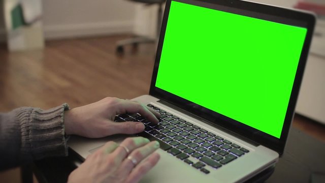 Computer green screen typing hands living room - 1080p. Hands typing on a green screen computer - Full HD
