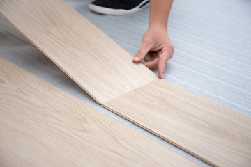 man installing new laminated wooden floor