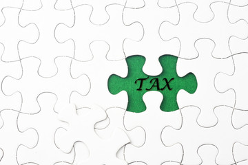 Fototapeta premium TAX word at missing puzzle