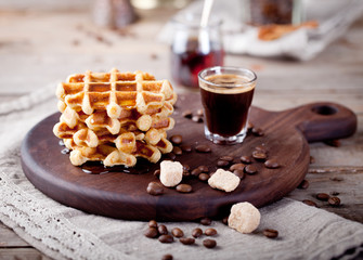 Fresh waffles with maple syrup and coffee 