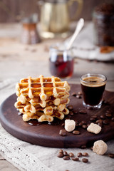 Fresh waffles with maple syrup and coffee 