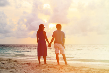 young romantic couple on the beach at sunset