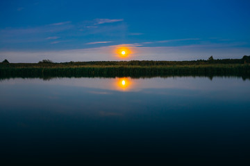 Wooden boards pier on Calm Water Of Lake, River