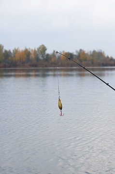 Rods and bait on the background of the autumn river
