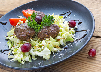 Trendy healthy low carb serving of meatballs and cabbage salad