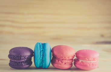 French macaroons on sack with wood background on filter color