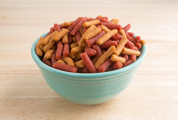 Fototapeta premium Small bowl of dog food on wood floor