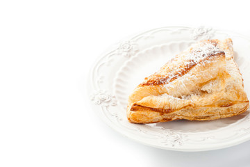 Cream puff with powdered sugar on the white plate horizontal