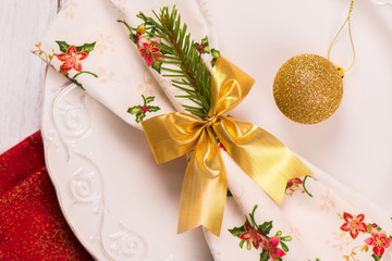 Christmas table setting with golden ball. New Year or Xmas concept. Toned  image