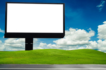 blank billboard with blue sky and green field