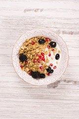 Crunchy granola with nuts, yogurt and fresh berries. Healthy breakfast concept. Top view