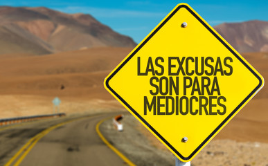 Excuses are for Average People (in Spanish) sign on desert road
