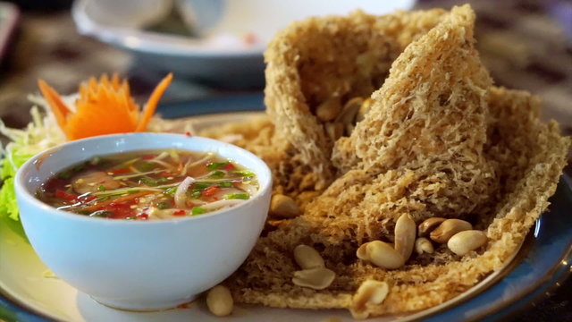 Fried catfish spicy salad, Asian Thai cuisine food. Serve with sweet and sour spicy sauce