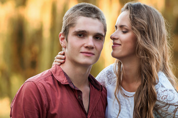 Fototapeta premium Portrait of a young couple against park