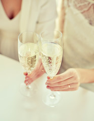 close up of lesbian couple with champagne glasses
