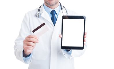 Doctor showing credit card and blank screen tablet