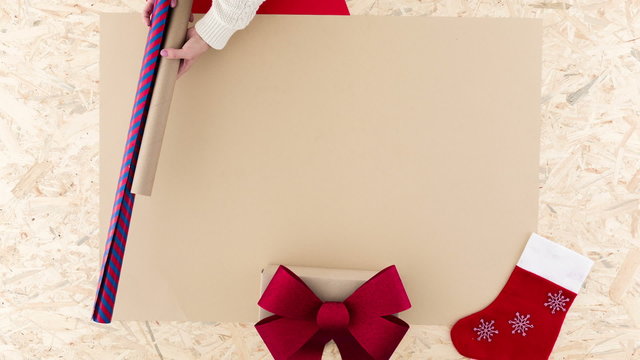Woman preparing for Christmas and packaging presents

