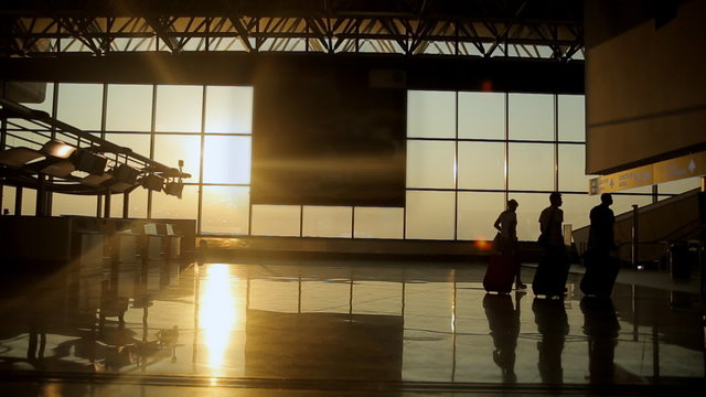 Silhouettes of travelers at the airport