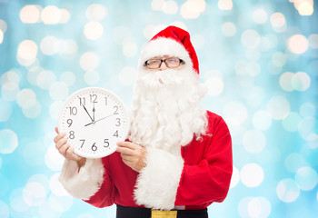 man in costume of santa claus with clock