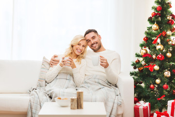 happy couple at home with christmas tree