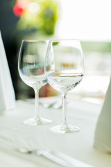 close up of two wine glasses on restaurant table
