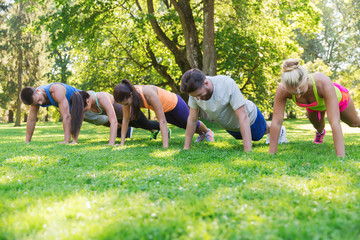 group of friends or sportsmen exercising outdoors