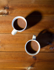 cups of hot chocolate or cocoa drinks on wood