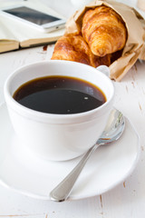 Coffee, croissants in paper bag
