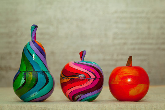 Wooden colorful pears and apples. Decorative fruit painted by hand. Handmade