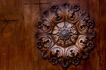 Detail embossed metal handle and an old door