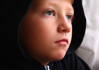 Young hooded child looking thoughtful