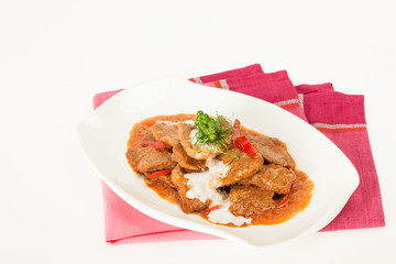 Fried beef in spicy red curry sauce with chilly and sour cream