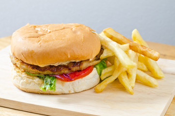 burger with french fries on wooden background
