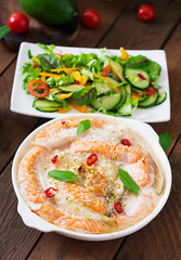 Baked slices of red and white fish with honey and lime juice, served with fresh salad.