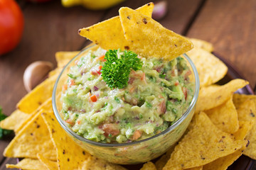 Guacamole avocado, lime, tomato, onion and cilantro, served with nachos - Traditional Mexican snack