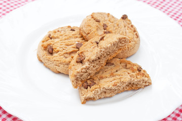 Chocolate chips cookies on white plate