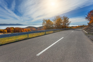 Driving on mountain road at beautiful autumn morning